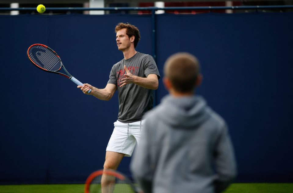  Andy Murray returns a forehand to Romeo Beckham as the pair have a hit-about ahead of the Aegon Championships at Queens Club in West London