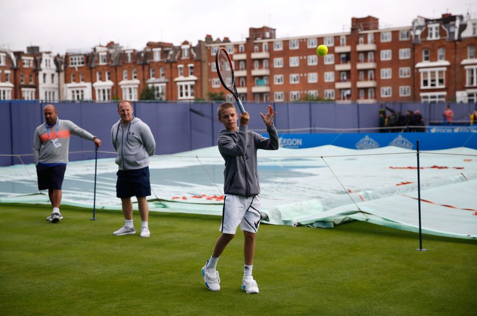  Romeo Beckham hits the ball back to Andy Murray Queens Club in West London ahead of the Aegon Championships grass court tournament