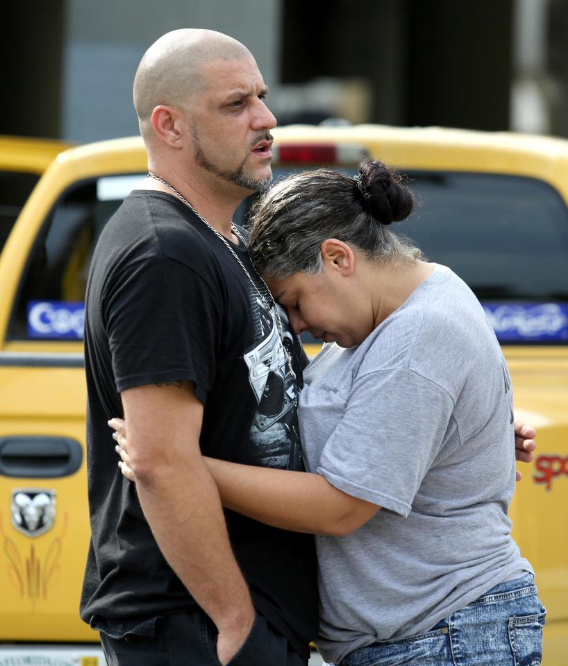 Orlando, USA. 12th June, 2016. Ray Rivera, DJ at the Pulse nightclub, is consoled by a friend outside of the Orlando Police Department on Sunday, June 12, 2016. ¿ Joe Burbank/Orlando Sentinel/TNS/Alamy Live News