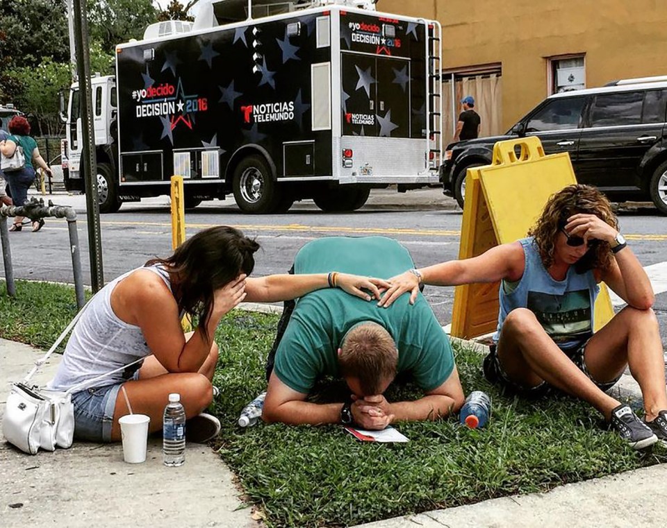  Mourners grieve near the scene of the nightclub horror