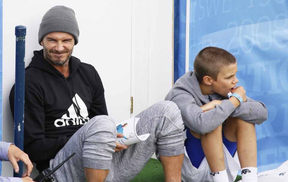  David and Romeo Beckham hang out while they watch Andy Murray's practice session