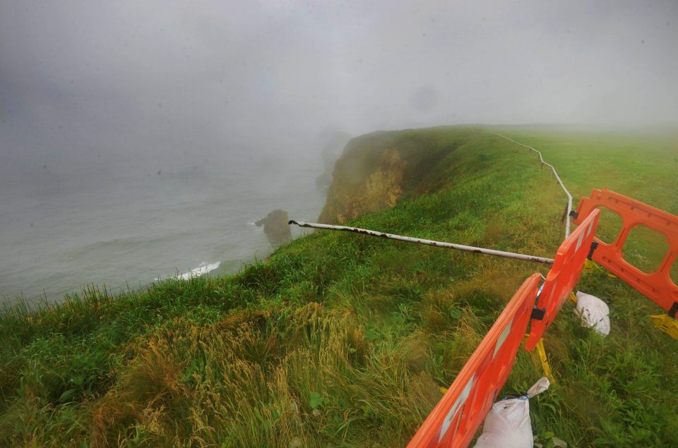 The car smashed through the railings and off the cliff edge