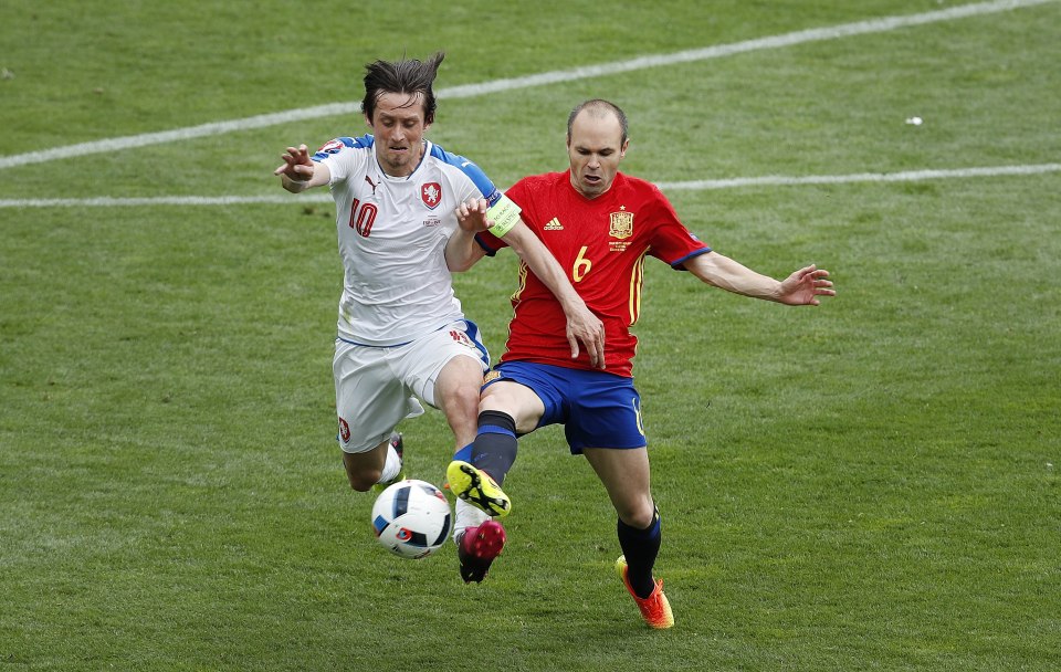  Andres Iniesta challenges former Arsenal man Tomas Rosicky for the ball