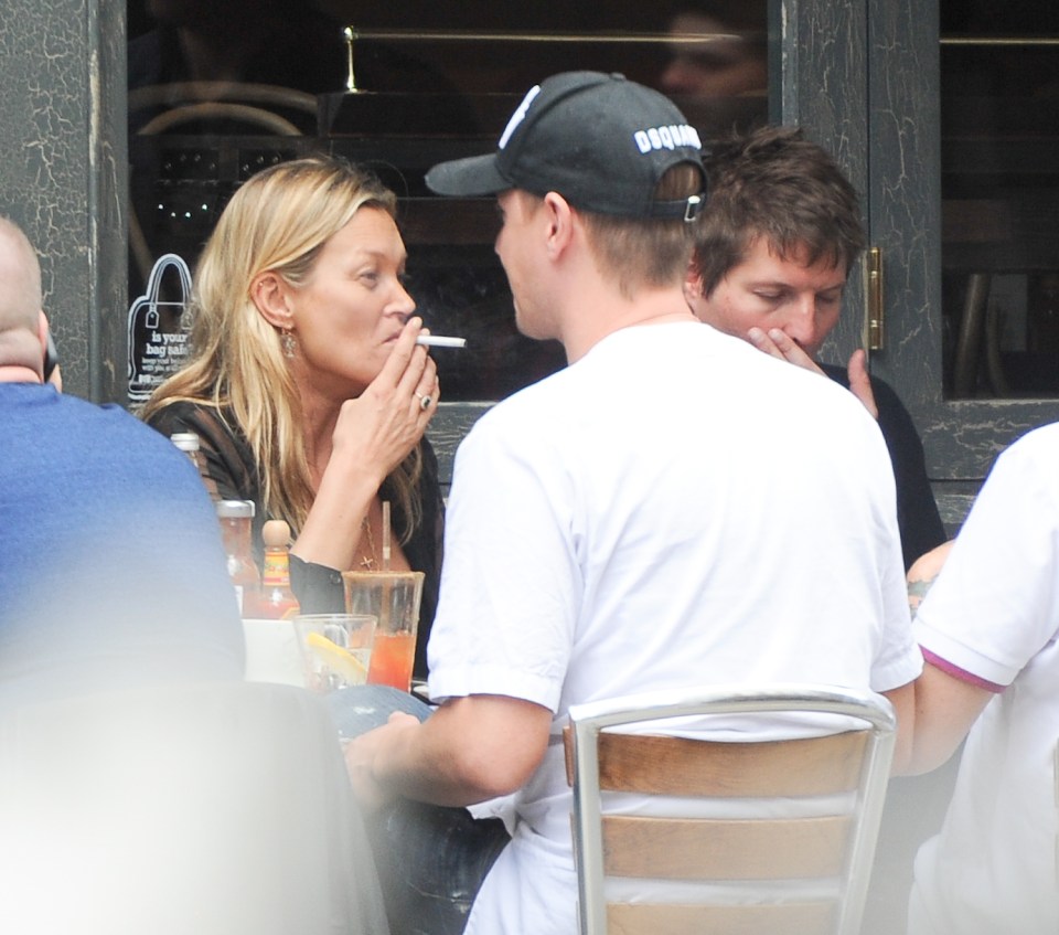  A cigarette break for Kate as she dines with Nikolai and friends