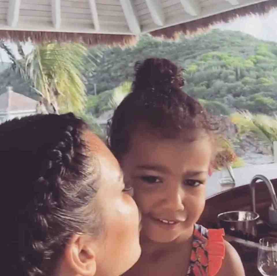  Kim gives her daughter a smooch for promising to stay little