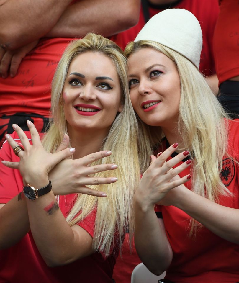  Two Albanian fans make the eagle symbol