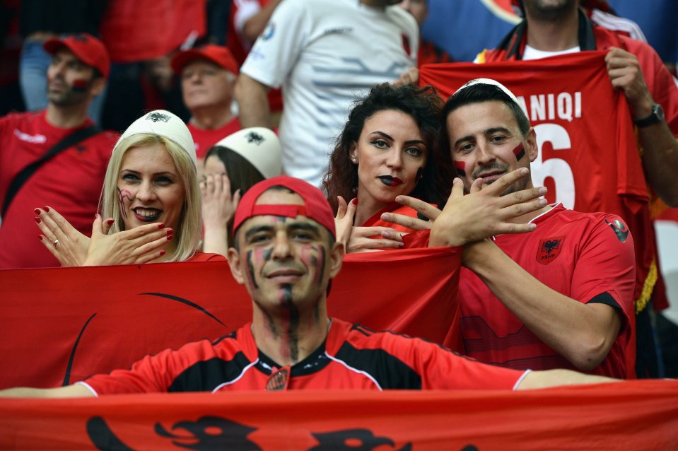  A group of fans make the Albanian eagle symbol