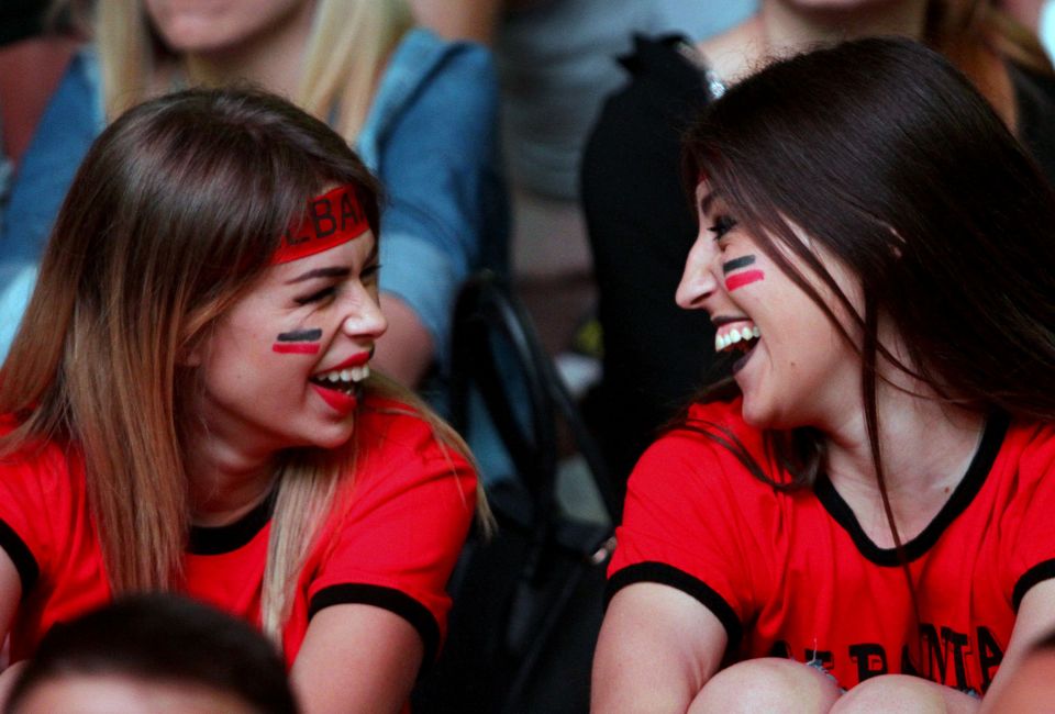  Two supporters are delighted as the action takes place