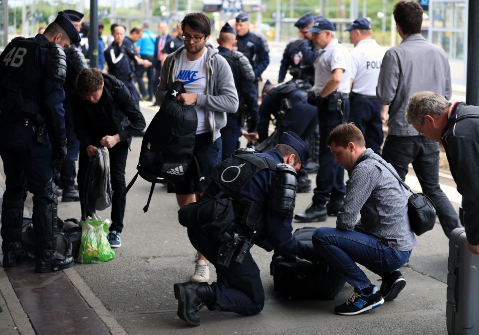  Police search bags at Lens railway station before as fans arrive for the match