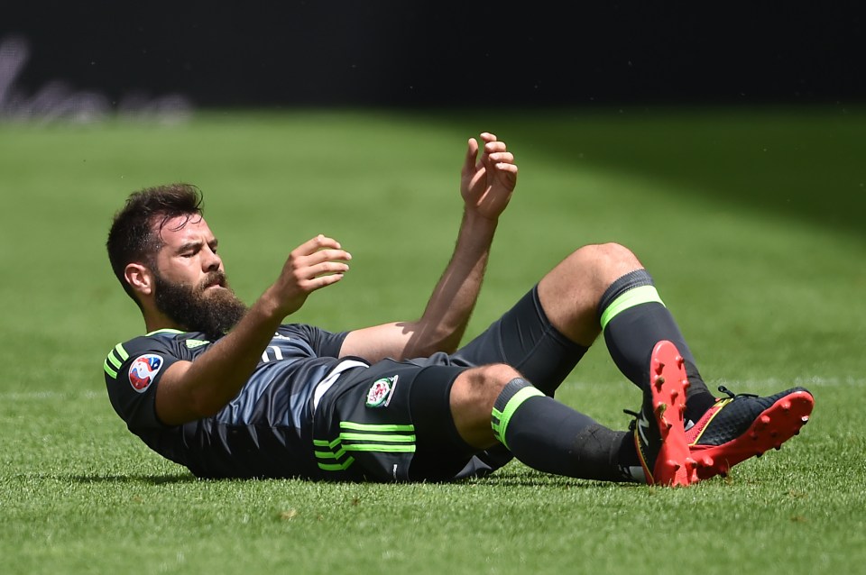  Joe Ledley lies injured on the pitch during Wales' 2-1 defeat to England