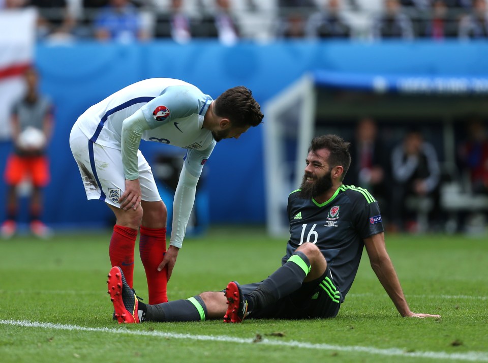  Adam Lallana checks to see what injury Joe Ledley suffered during the match