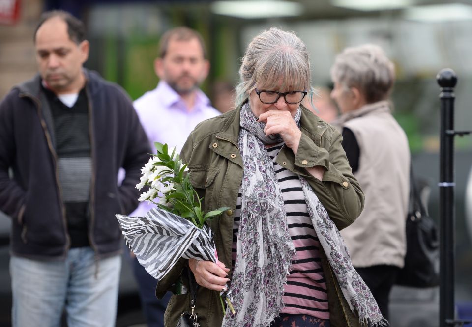  A woman arrives to lay flowers near to the scene where Labour MP Jo Cox was killed this afternoon