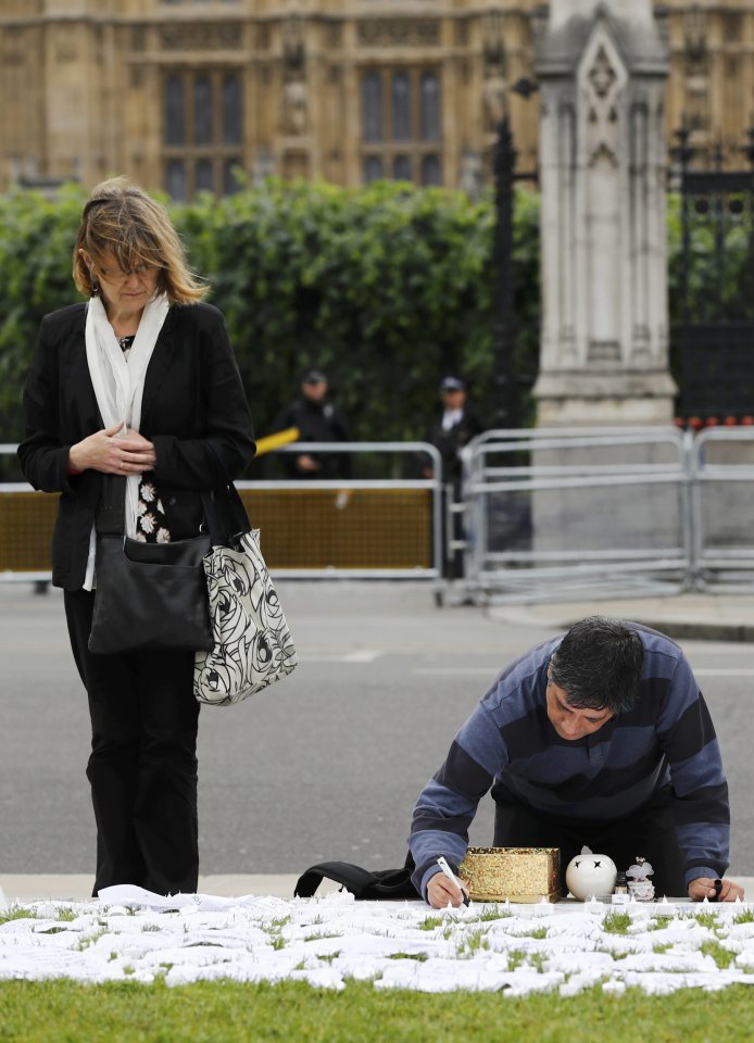  Mourners pay tribute to Jo Cox outside parliament this morning