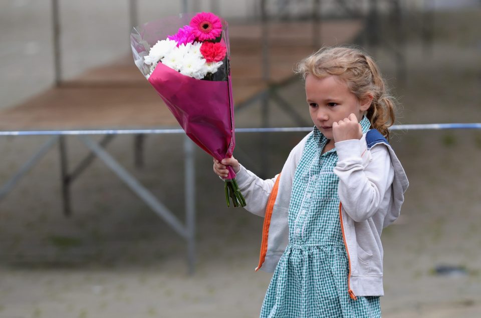  A young girl leaves flowers in Market Square for mum-of-two Jo Cox whose life was taken yesterday