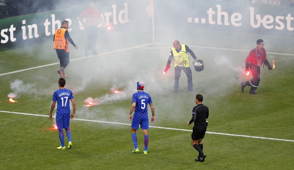  The match was stopped minutes before full-time as flares were chucked on the pitch