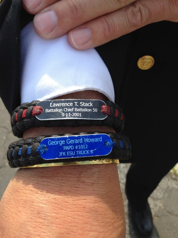 Chief Rich Brandt displays bracelets with the names fallen colleagues