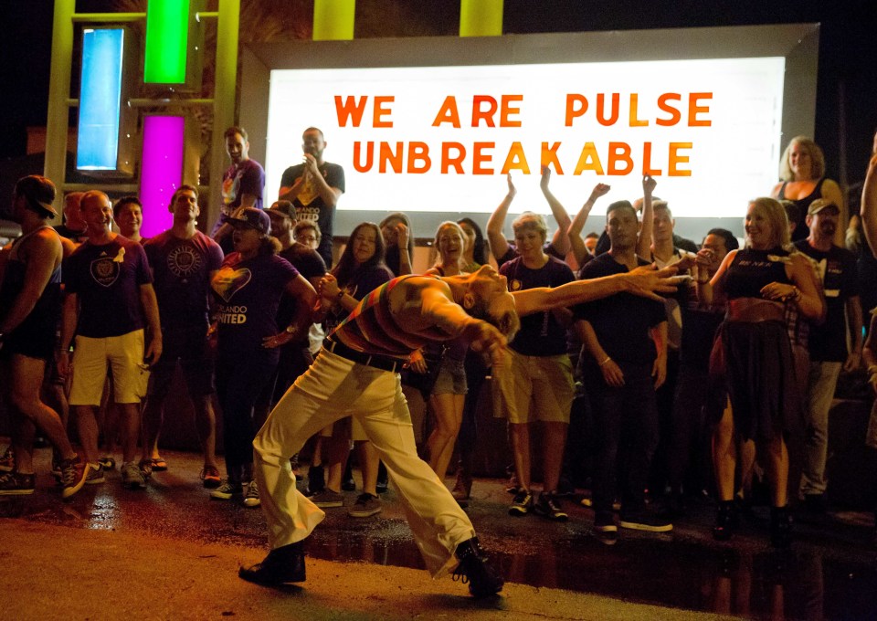  Steven Johnson dances amongst club goers as they gather outside Parliament House, an LGBT nightclub, close to the one week anniversary of the Pulse nightclub mass shooting