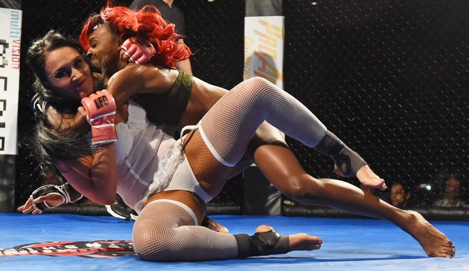  Sheila "Crash" Cardinal (L) and MaiNe "Main Event" Morgan fling each other around the ring