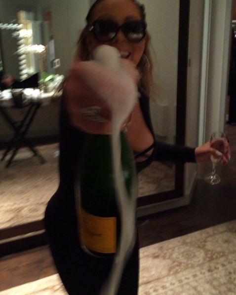  Mariah was in good spirits as she popped a bottle of champagne