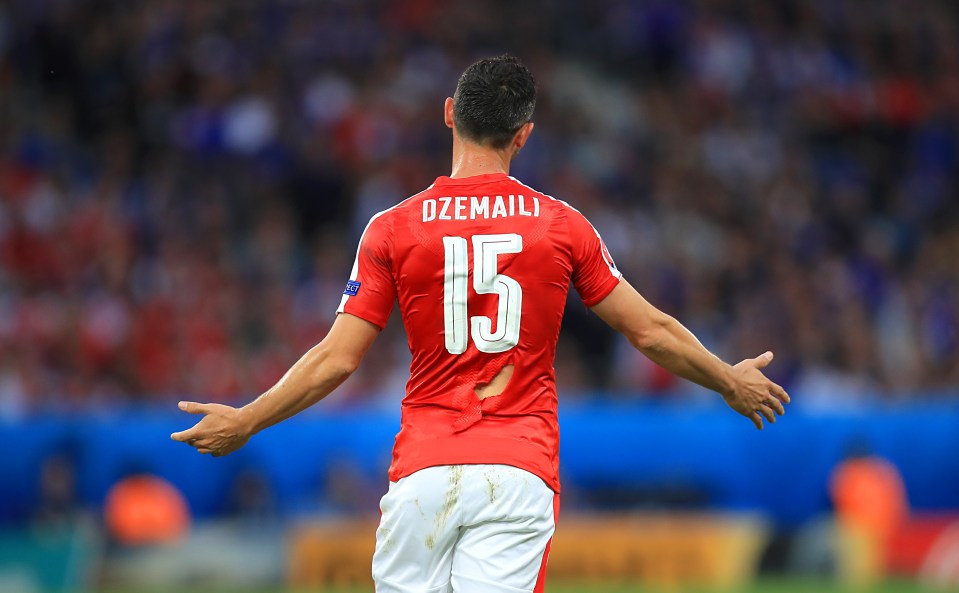  Switzerland's Blerim Dzemaili with a ripped shirt against France