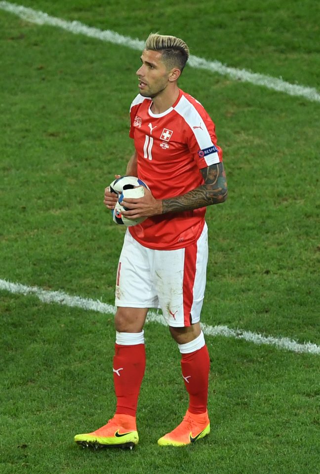  Valon Behrami holds the deflated Adidas match ball after his tackle