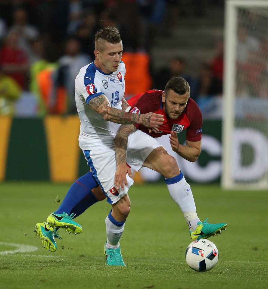 Jack Wilshere is muscled off the ball by Slovakia star Juraj Kucka