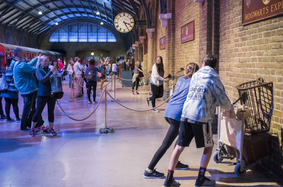  Guests pose with trolleys at Platform 9 3/4