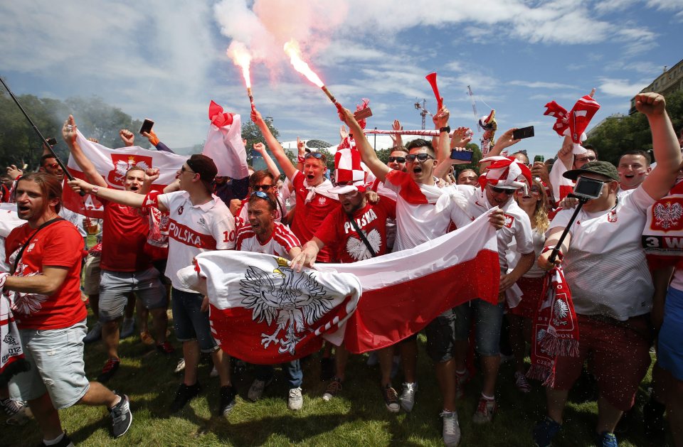 Poland fans spark flares outside the stadium in Marseilles