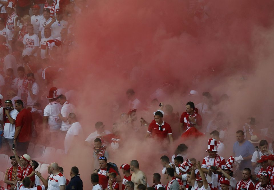 Smoke enguls supporters during the Group C clash