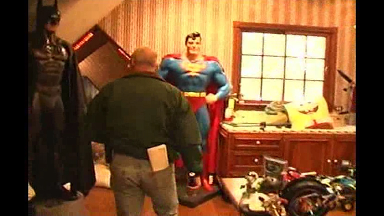 A giant Superman is spotted during the footage of the police raid