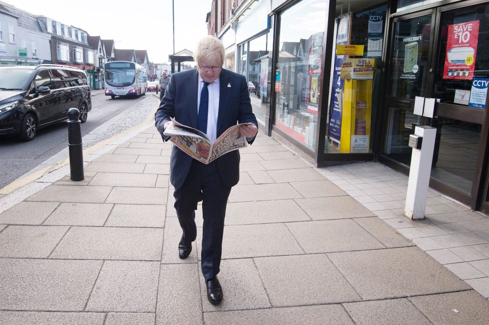  Boris reads a copy of The Sun as he spends time in Essex as part of his tour of the UK today