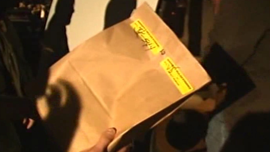 The newly released footage showed police taking a brown paper bag from the home as they discussed the items they had found in the home