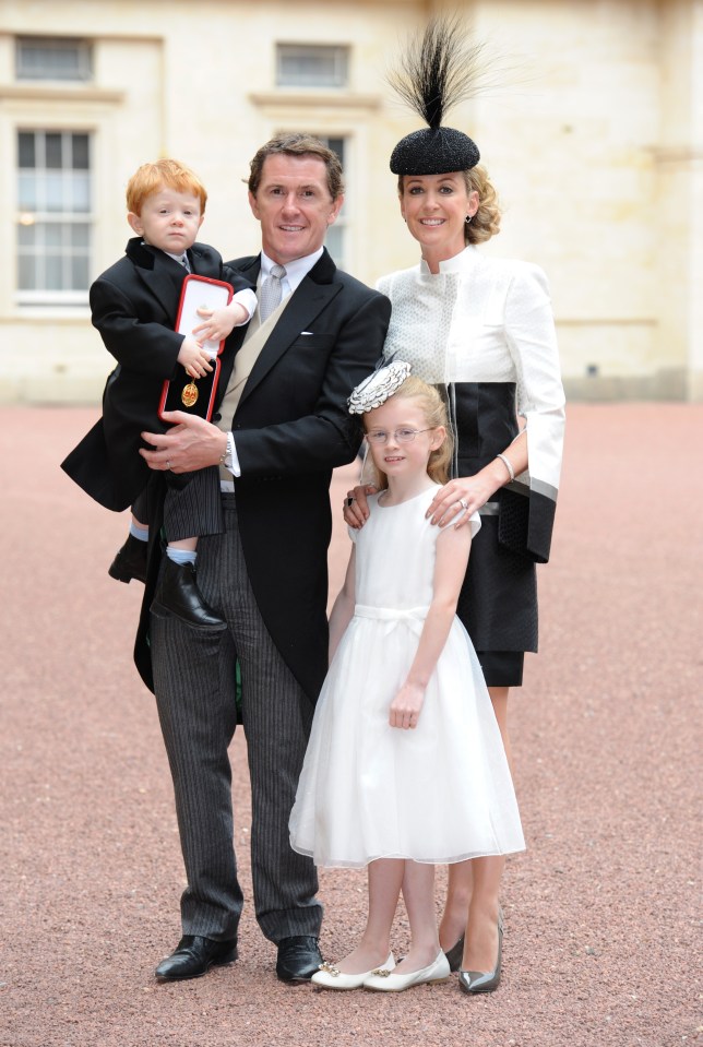  Photo finish ... Sir Tony with his family at Buckingham Palace