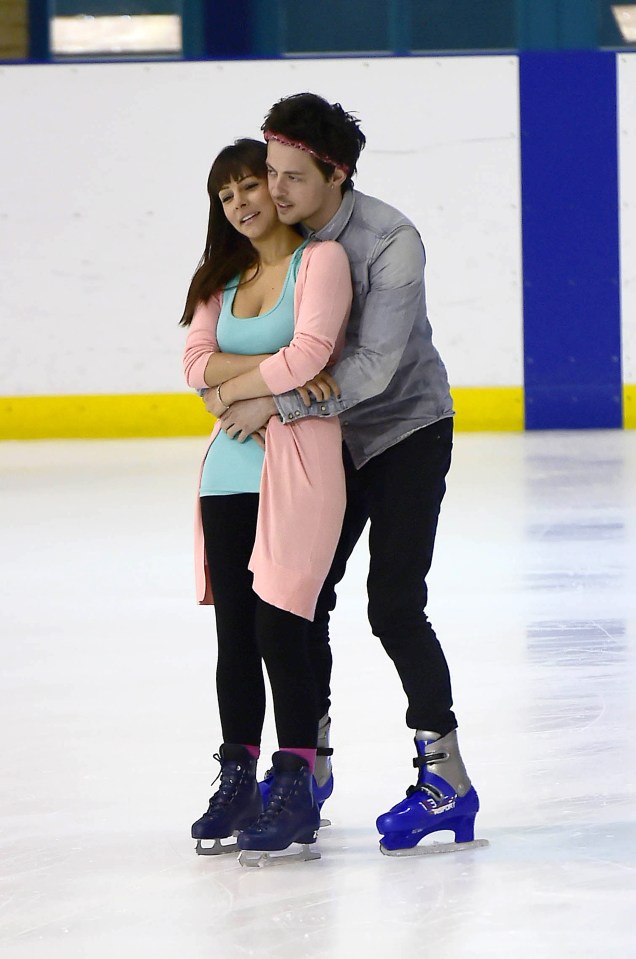 Elliot wrapped his arms around his girlfriend as they skated along 