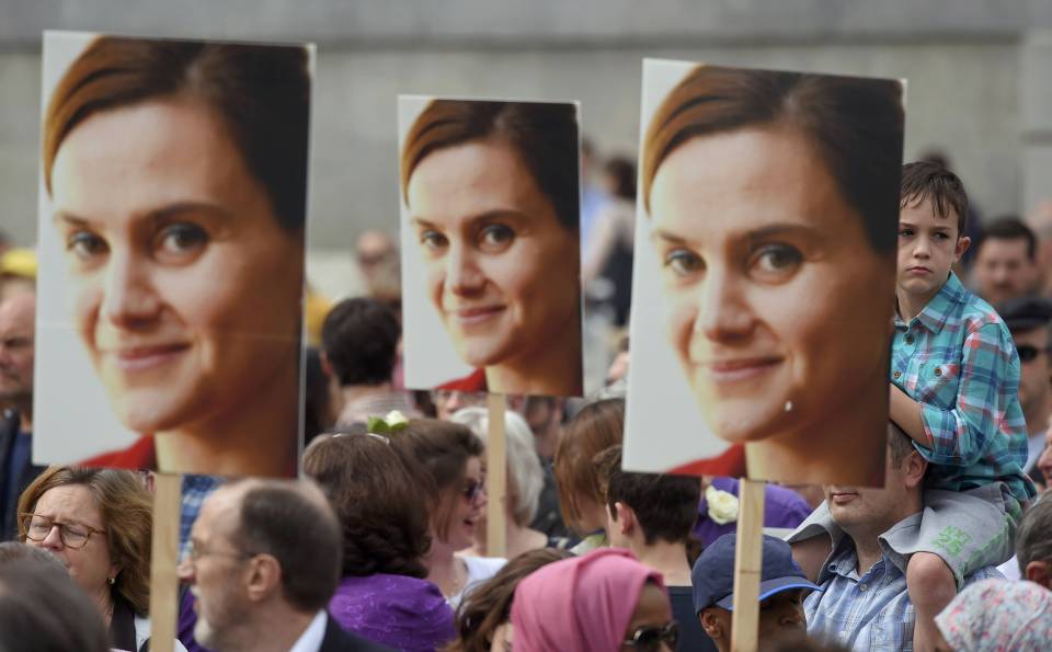  People hold banners of murdered Labour Party MP Jo Cox, during a special service at Trafalgar Square