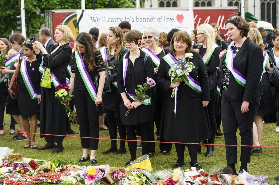  Wearing sashes in the colours of the suffragettes Jo Cox's friends laid floral tributes outside the Houses of Parliament