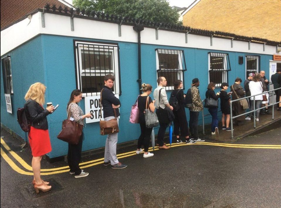  Voters queue outside a polling station in Hackney