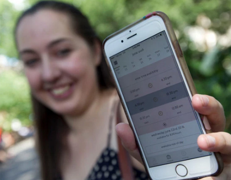  Emily Pidgeon poses with the Hello Sitter app on her iPhone Wednesday in New York. Pidgeon, 23, of Gramercy, is a babysitter of the Uber-like childcare service where parents can schedule a sitter with as little as an hour'snotice