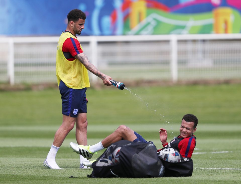  Dele Alli is sprayed with water by Spurs team-mate Kyle Walker