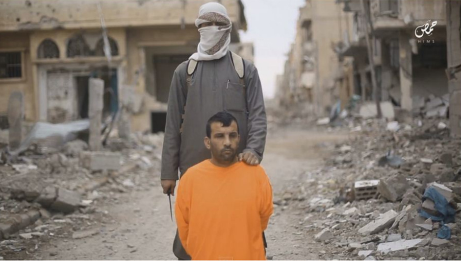  In a classic ISIS execution the prisoner wore orange overalls and knelt at the feet of his killer