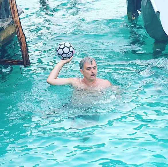  Jose Mourinho can't escape a football as he relaxes in the pool on holiday