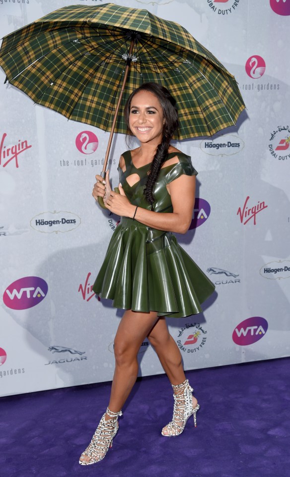  Heather Watson dressed for the weather with a large umbrella that matched her dress