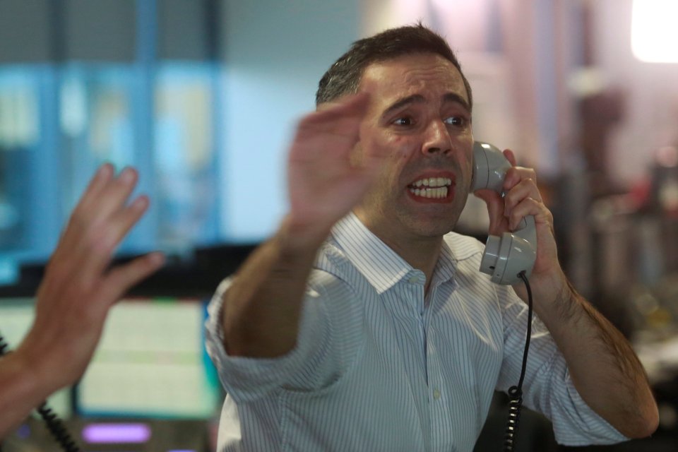  Traders shout across the trading floor as the City got off to a frenzied start