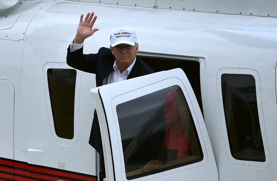  Trump waves as he emerges from the chopper