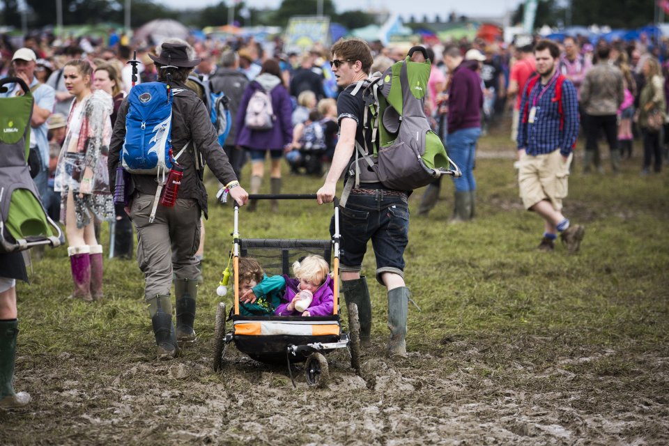 Two children are pulled through the mud this morning at Glastonbury Festival. June 24 2016.