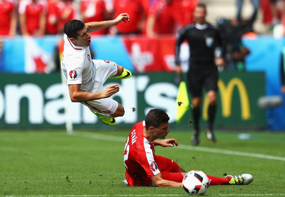  Robert Lewandowski is fouled hard by Fabian Schar