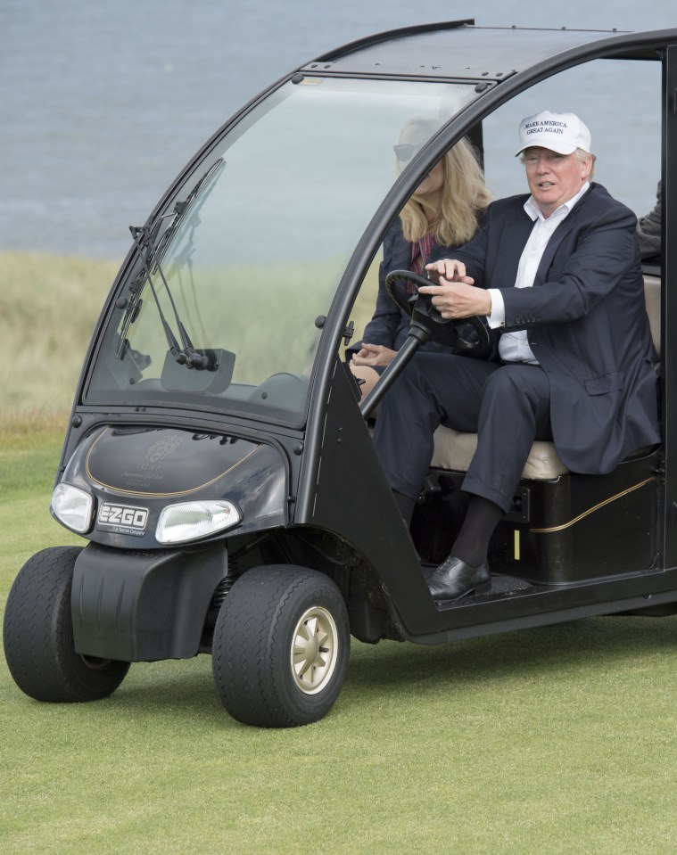  Trumping around ... Donald on a buggy on his Aberdeen golf course