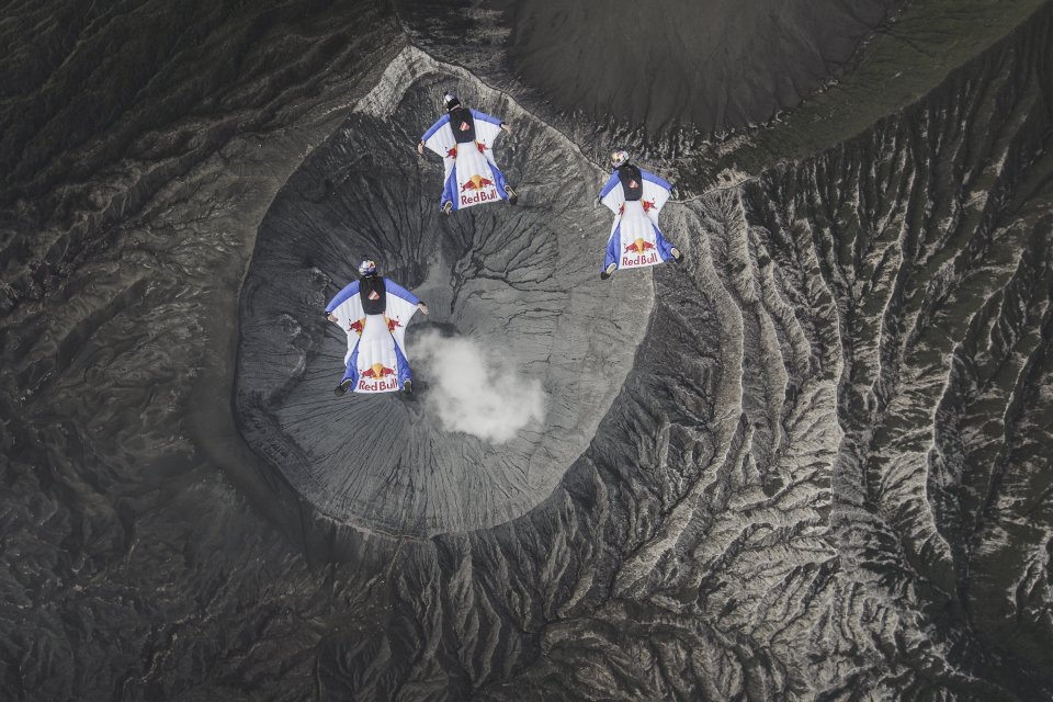  A trio of wingsuit pilots divers descend over the crater of Mt. Bromo, Indonesia