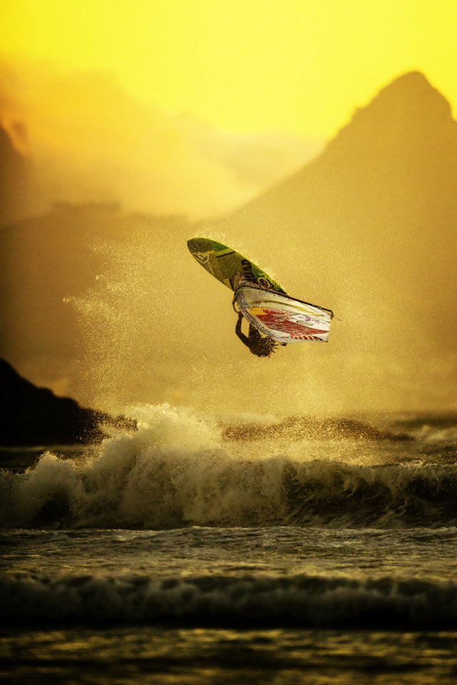  Surfer Alice Arutkin rides a wave in Cape Town, South Africa, as the African sun sets behind her