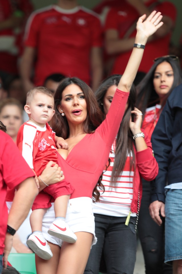  Blerim Dzemaili's other half holds her son up so he can get a great view of the contest